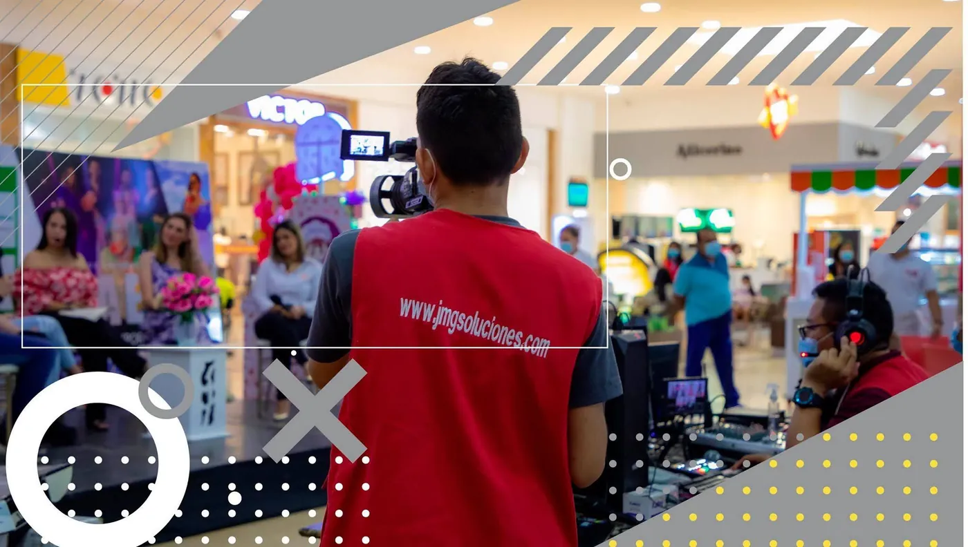 Camarógrafo de JMG graba el set de un conversatorio en un centro comercial de Riohacha, con el operador de audio al lado.